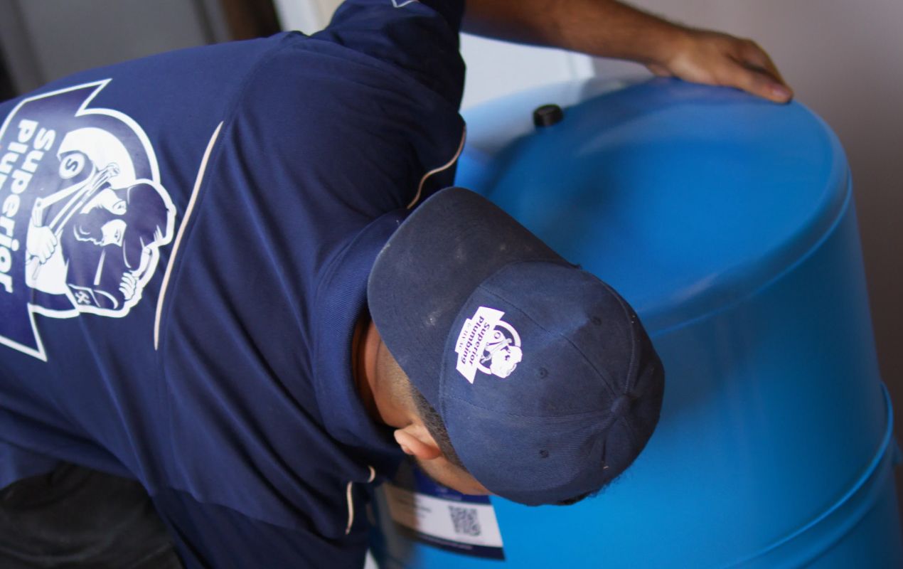 Superior Plumbing & Heating expert inspecting the system setup during a well pump installation local