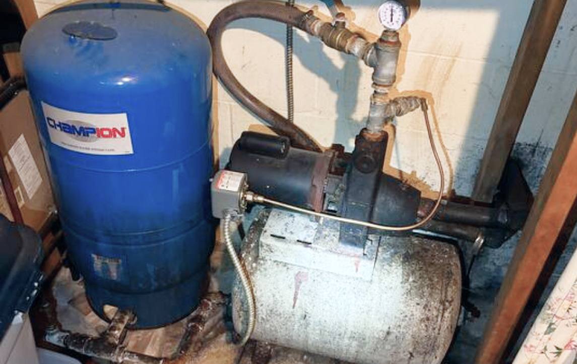 Old jet pump motor before well pump replacement local by Superior Plumbing & Heating.