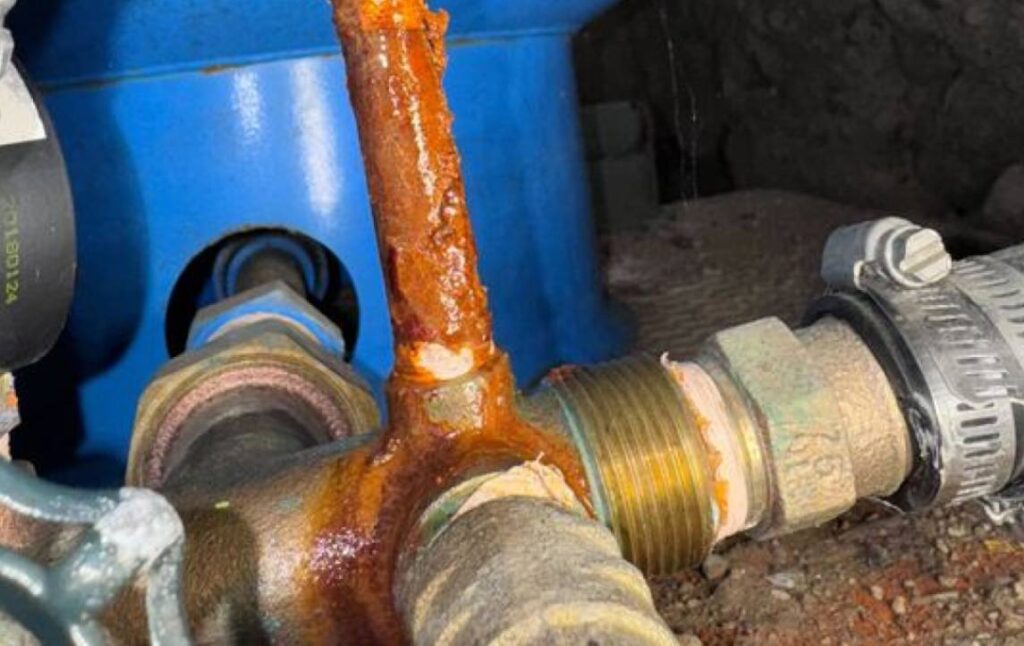 Rusty pipe fitting needing well pump replacement local from Superior Plumbing & Heating.