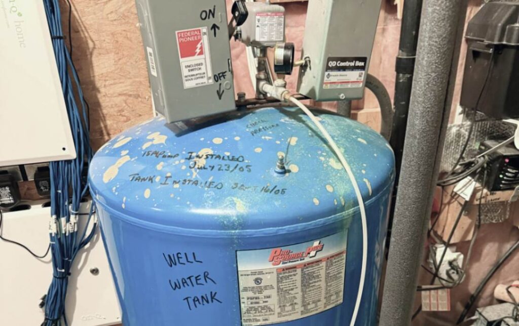 Checking water tank labels for Well pump repair local by Superior Plumbing & Heating.