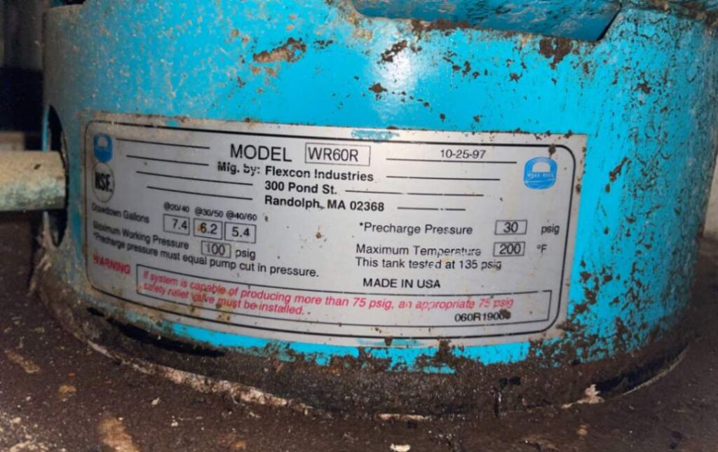 Checking tank data plate for Well pump repair local by Superior Plumbing & Heating.
