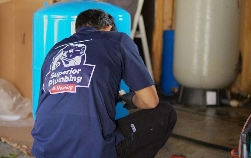 Expert well pump repair local in a basement by Superior Plumbing & Heating technician.