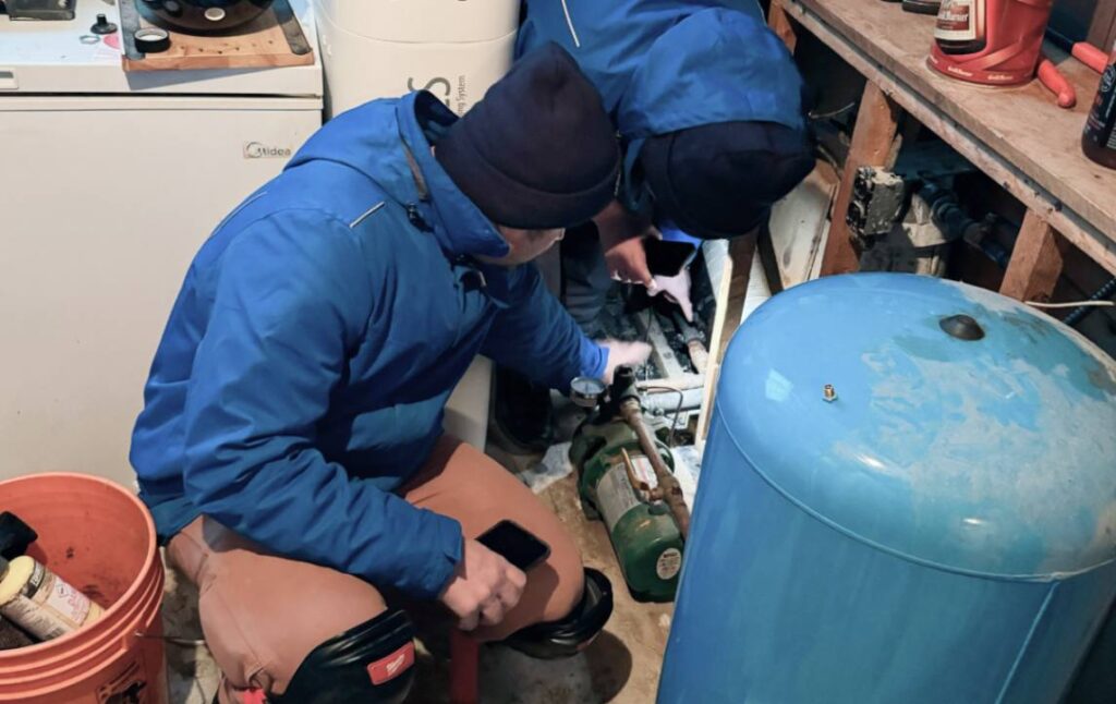 Superior Plumbing & Heating tech inspecting system components for Well pump repair local.
