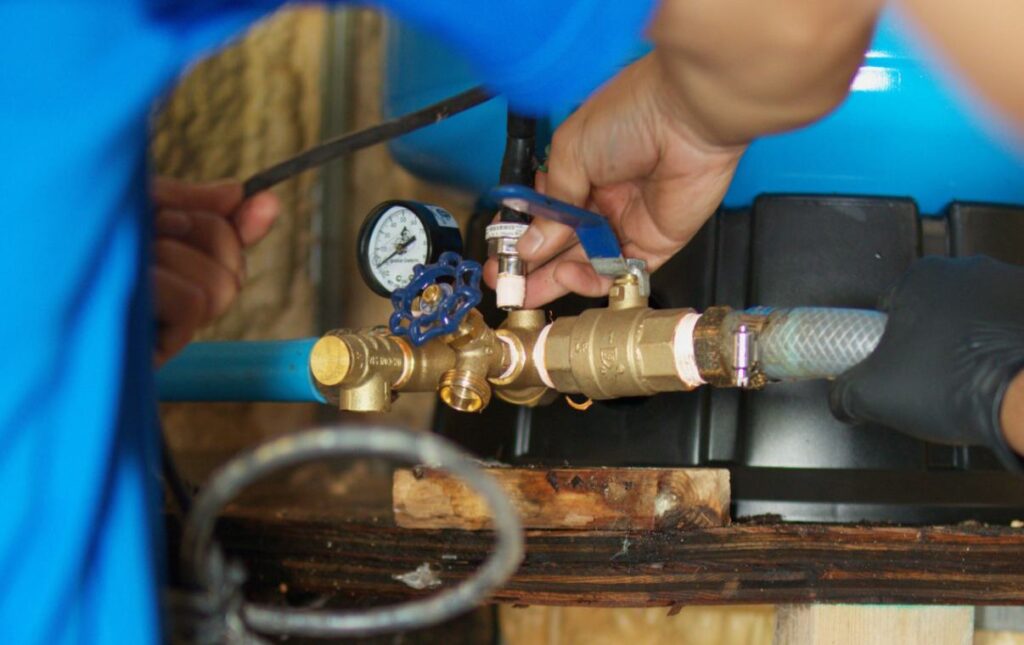 Close-up of brass manifold setup during a well pump repair by Superior Plumbing & Heating