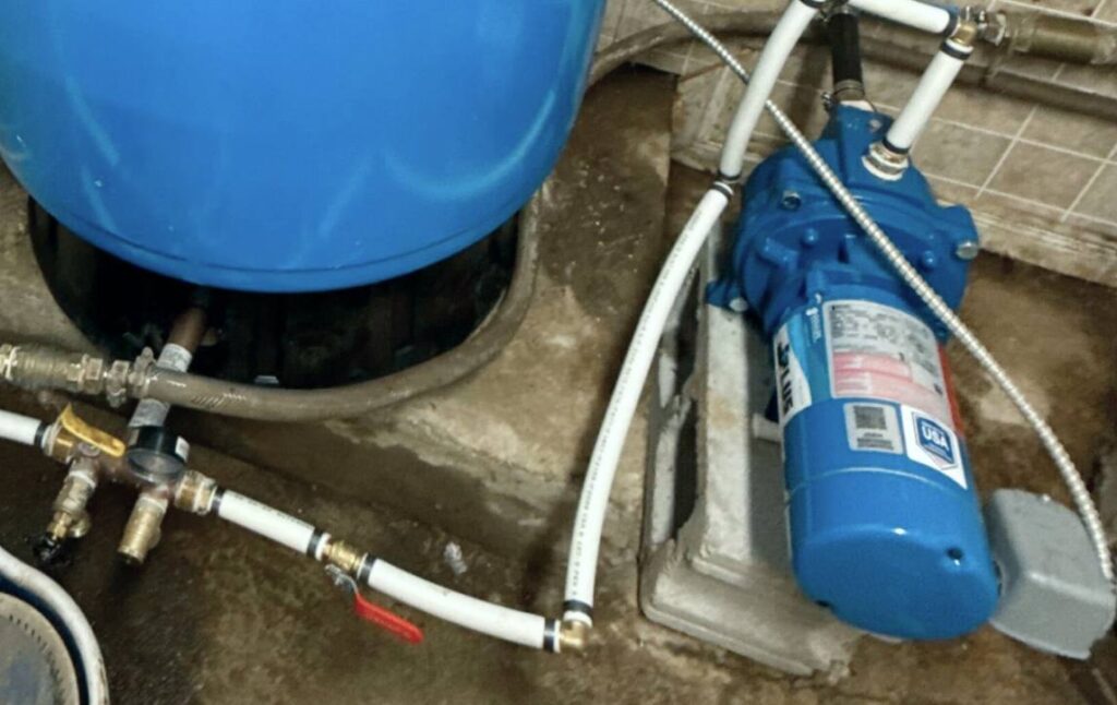 New water lines and pump components connected during a well pump replacement local project by Superior Plumbing & Heating