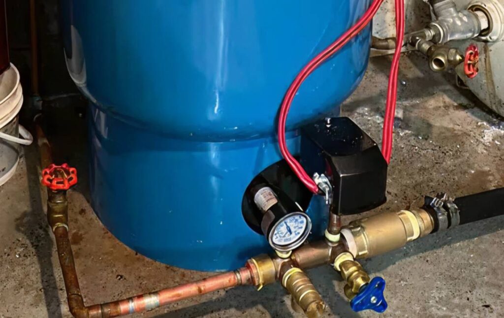 Close-up of a pressure switch and gauge installed during a well pump replacement local by Superior Plumbing & Heating