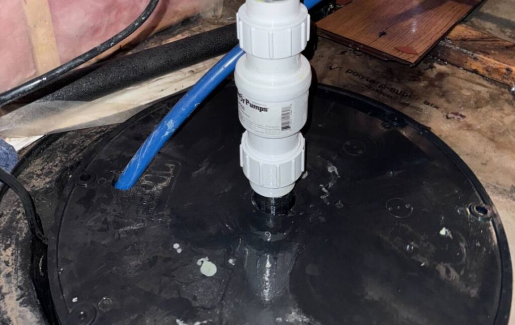 New check valve and discharge piping for a Sump pump replacement local by Superior Plumbing & Heating.