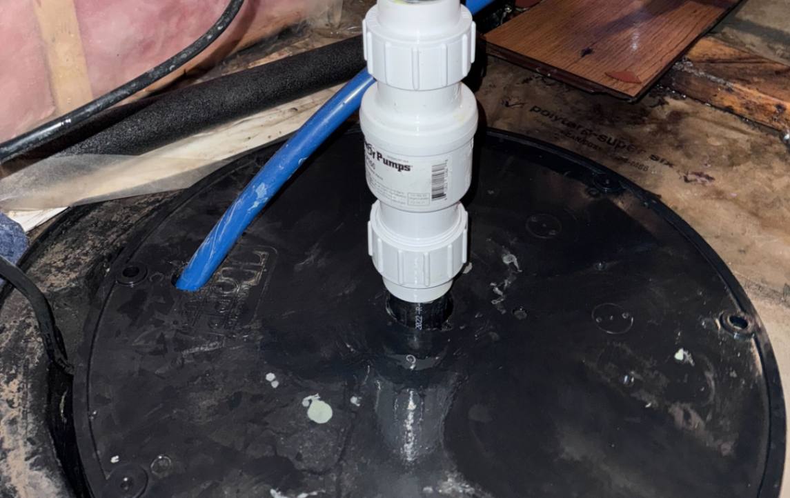 New check valve and discharge piping for a Sump pump replacement local by Superior Plumbing & Heating.