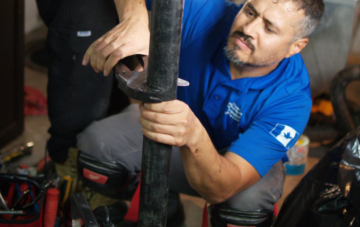 Superior Plumbing & Heating expert adjusting a discharge pipe for a Sump pump replacement local.