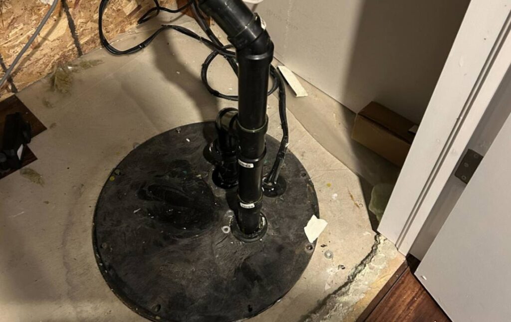 Sealed black basin lid after a successful Sump pump replacement local by Superior Plumbing & Heating.