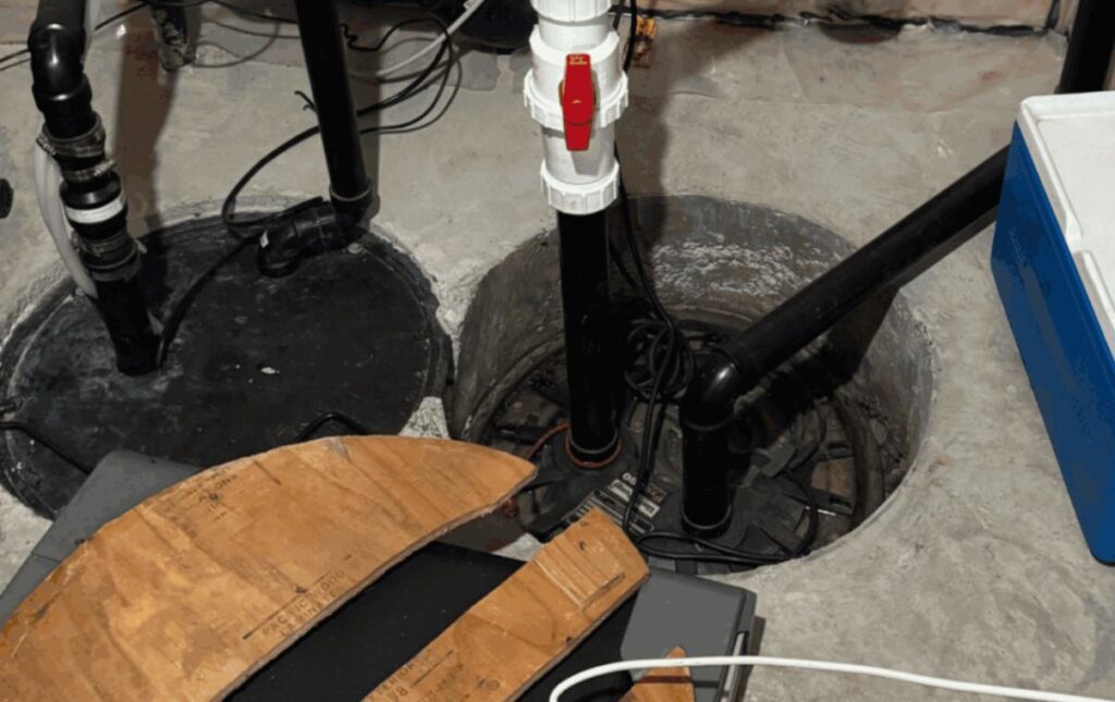 Completed discharge setup and basement floor cleanup after sump-pump-replacement local by Superior Plumbing & Heating.