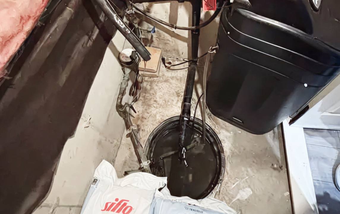 Sump pit with a battery backup system following a sump-pump-replacement local by Superior Plumbing & Heating.