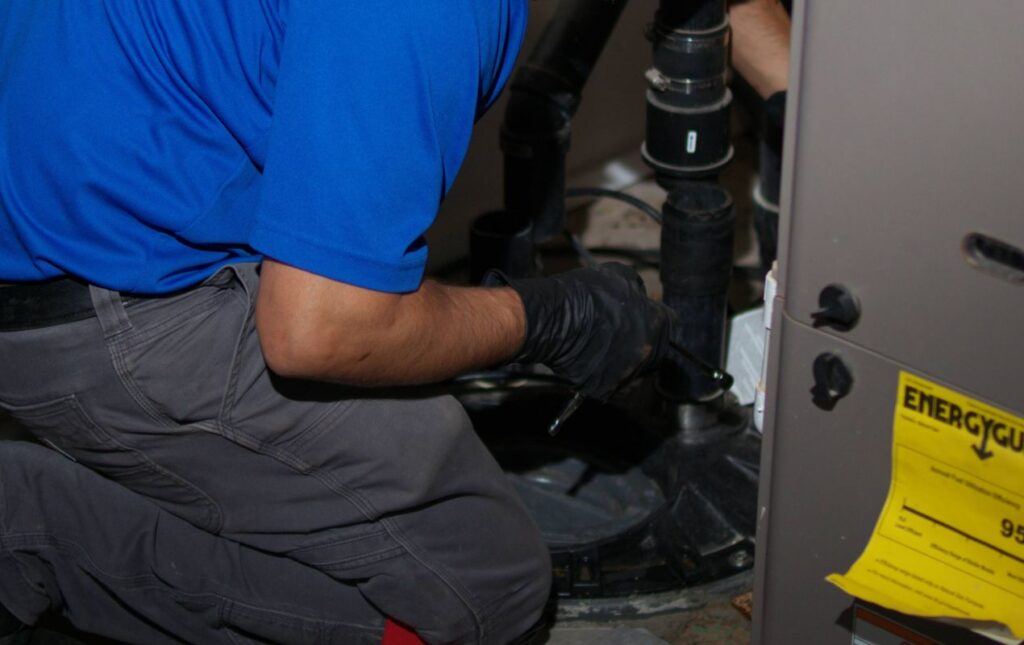 Superior Plumbing & Heating specialist hands-on during a Sump pump replacement local service.