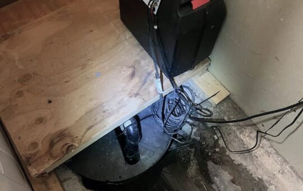 Mounting a pump control box during a Sump pump replacement local by Superior Plumbing & Heating.