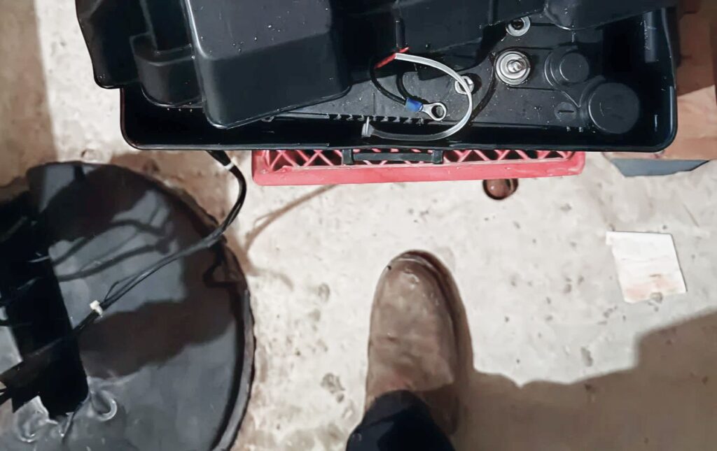 Superior Plumbing & Heating pro finishing a Sump pump replacement local on a concrete floor.