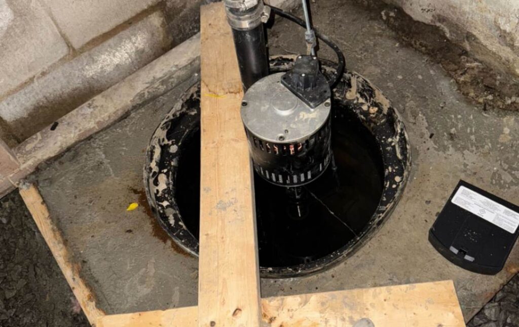 High-performance pump in a basin during Sump pump replacement local by Superior Plumbing & Heating.