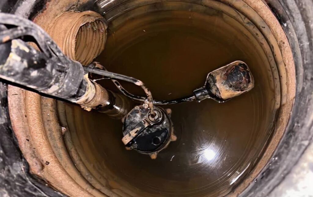 Adjusting a float switch in a wet basin for a sump pump repair local by Superior Plumbing & Heating.