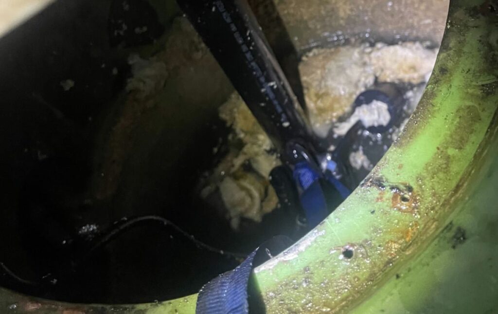 Troubleshooting dirty water buildup in a pit for a sump pump repair local by Superior Plumbing & Heating.