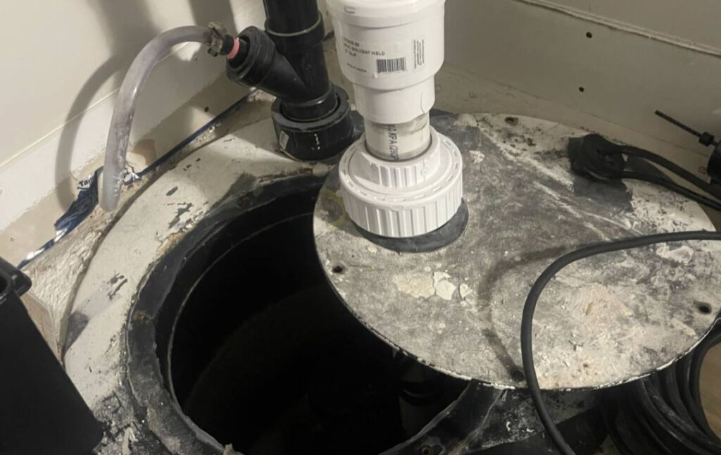 White PVC check valve repair during a sump pump repair local by Superior Plumbing & Heating.