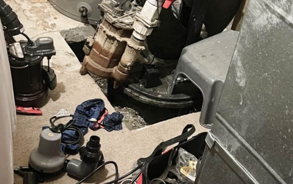 Cleaning up the basement floor after a successful sump pump repair local by Superior Plumbing & Heating.